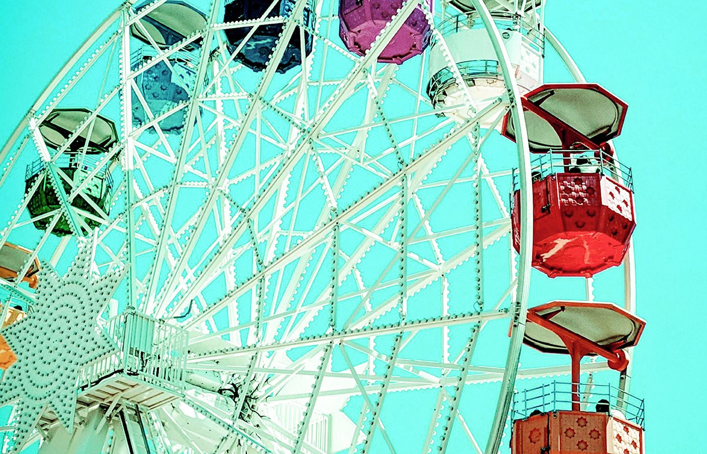 angled shot of carousel with variety of coloured cars